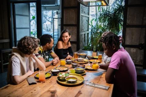 A multicultural group of students in a cafe, eating asian food, Stock Photos