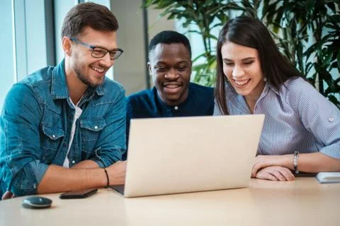 Multicultural group of students discussing project Stock Photos