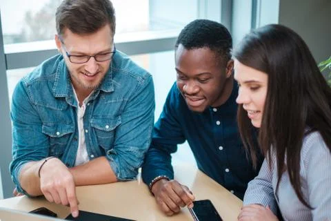 Multicultural group of students discussing project Stock Photos