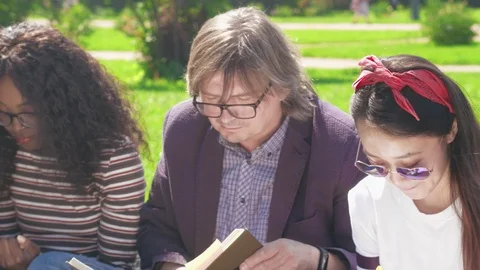 Multicultural group of students having outdoor lesson Stock Footage 93244082