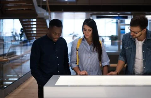 Multicultural group of students in a public library Stock Photos
