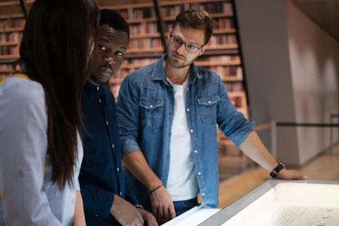 Multicultural group of students in a public library 스톡 사진