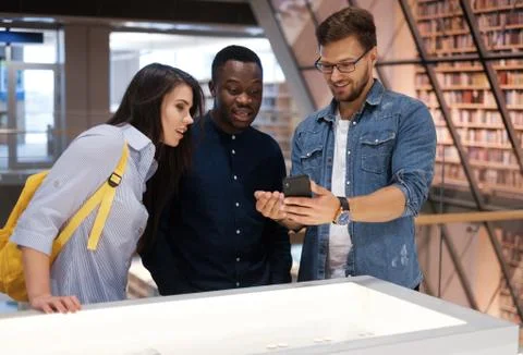 Multicultural group of students in a public library Stock Photos