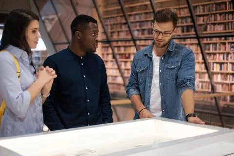 Multicultural group of students in a public library Photos