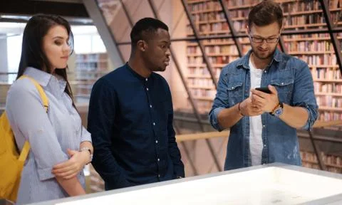 Multicultural group of students in a public library Stock Photos