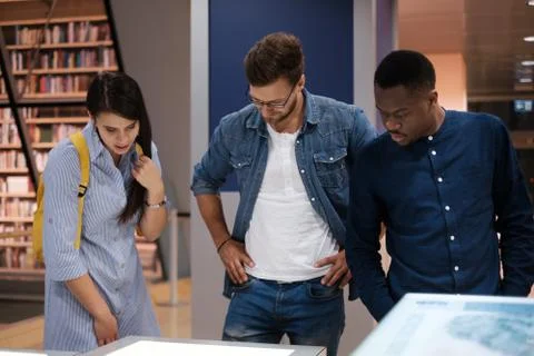 Multicultural group of students in a public library Foto stock