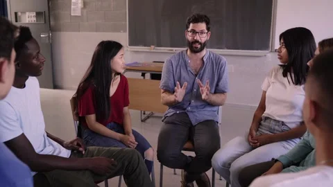 Multicultural group of undergraduate students sitting in chairs forming a circle Stock Footage 246831152
