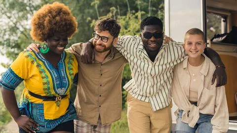 Multicultural group of young friends bonding outdoors and having fun. Motorhome Stock Photos