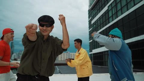 Multicultural hip-hop group dance together at rooftop with city view. Endeavor. 스톡 사진