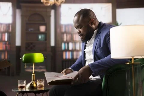 Multicultural intelligence agents in a bureau reading top secret documents Stock Photos