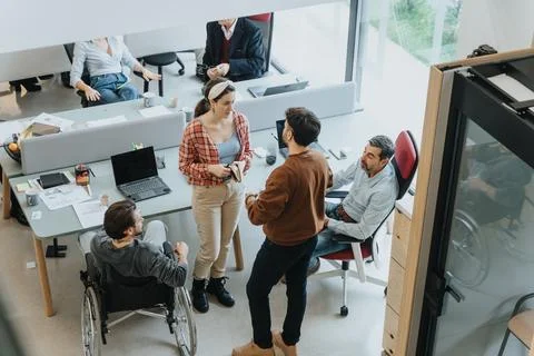 Multicultural, inter generational group of business colleagues having a Stock Photos