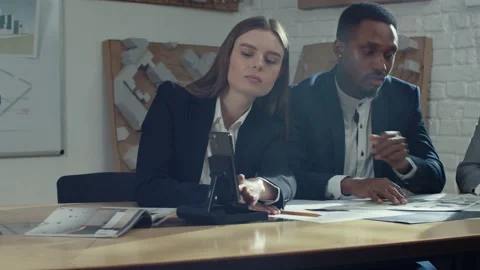 Multicultural office staff sitting at desk in meeting room, calling via internet Stock Footage 189037193