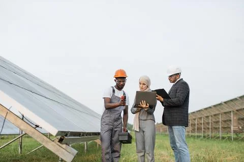 Multicultural people checking temperature of solar panels Фото