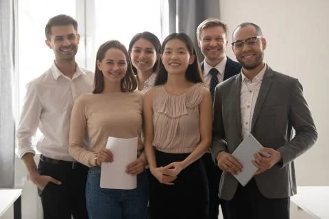 Multicultural professional work team happy employees group looking at camera Stock Photos