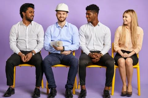 Multicultural project team looking at construction engineer Stock Photos