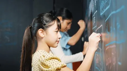 Multicultural student writing engineering code with site view. Edification. Stock Photos