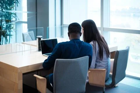 Multicultural students studying in a public library Stock Photos