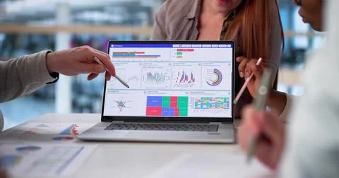 Multicultural Team Analyzing Demographic Data In Collaborative Business Meeti Stock Photos
