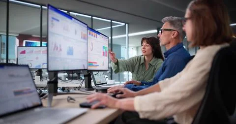 Multicultural Team Analyzing Performance Data Using KPI Dashboard In Office Stock Photos