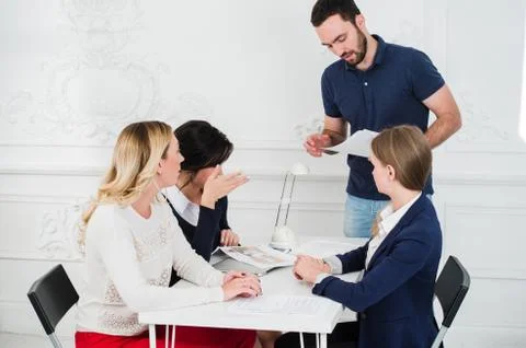 Multicultural team of designers looking at a project Stock Photos