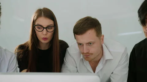 Multicultural team discusses the progress of work looking at the computer Stock Footage 195307144