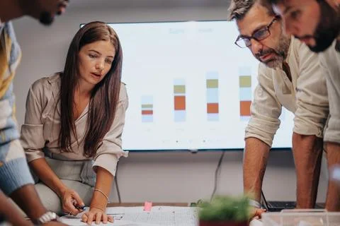 Multicultural Team of Engineers Collaborating in a Conference Room, Discussing Stock Photos