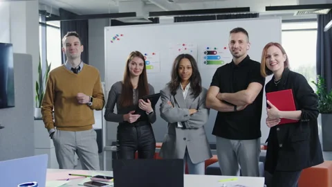 Multicultural team of five posing for the camera in the office Stock Footage 193985703