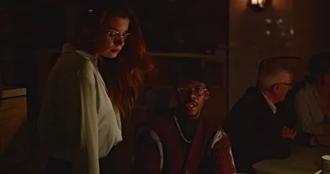 A multicultural team of workers collaborating intently on a project after hours Stock Footage 277296908