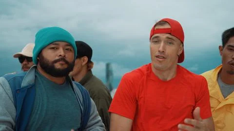 Multicultural teenagers dancing while looking at camera on rooftop. Endeavor. 스톡 사진