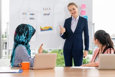 Multicultural working group in teamwork meeting. Stock Photos