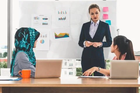 Multicultural working group in teamwork meeting. Stock Photos