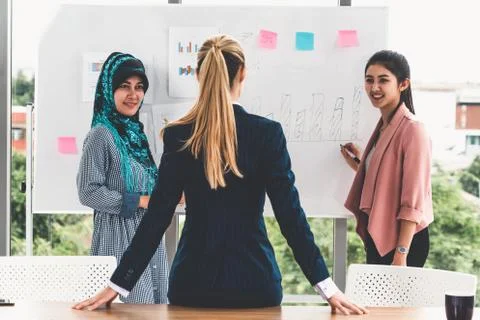 Multicultural working group in teamwork meeting. Stock Photos