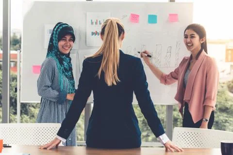 Multicultural working group in teamwork meeting. Stock Photos