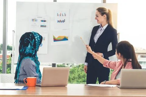 Multicultural working group in teamwork meeting. Stock Photos