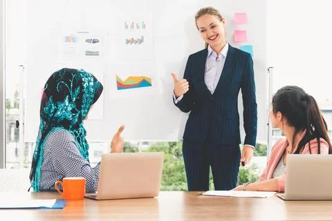 Multicultural working group in teamwork meeting. Stock Photos