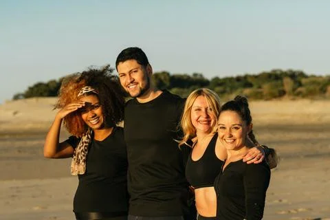 Multicultural yoga class group standing facing the camera outdoors Stock Photos