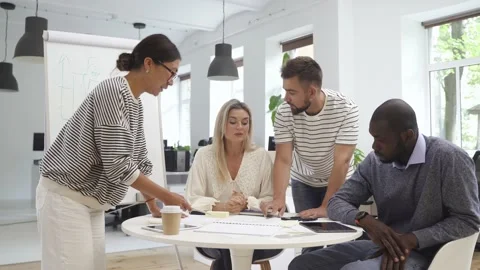 Multicultural young people collaborating on working strategy in office. Stock Footage 233705984