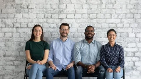 Multiethnic applicants sit on chairs wait turn for job interview Stock Photos