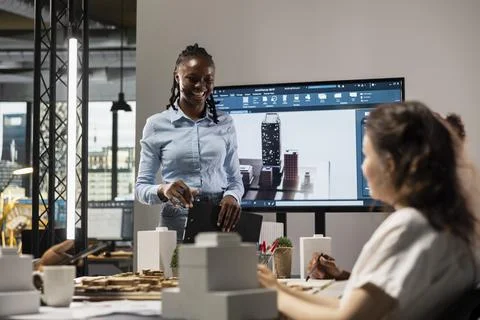 Multiethnic architecture developers team use 3D models in brainstorming meeting Stock Photos