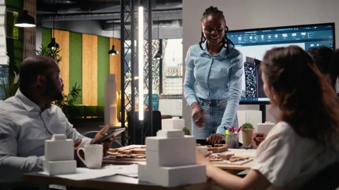 Multiethnic architecture developers using 3D models in brainstorming meeting Stock Footage 316647713