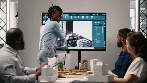 Multiethnic architecture developers using 3D models in brainstorming meeting Stock Footage 316794849