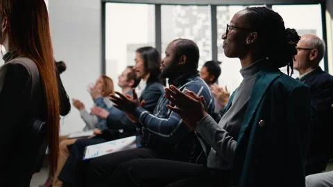 Multiethnic audience applauding and greeting presenter during discussion Stock Footage 327823914