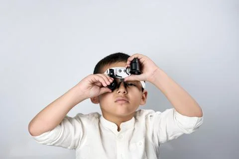 Multiethnic boy in magnifying eyeglasses Stock Photos