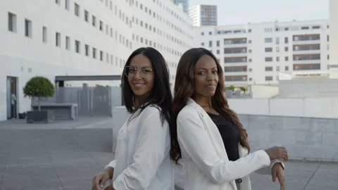 Multiethnic business partners posing back to back with crossed arms Video stock 97447780