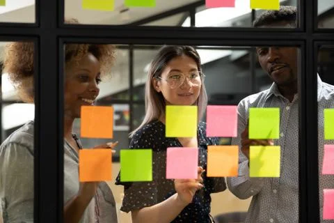 Multiethnic business team brainstorm write ideas on sticky notes Stock Photos