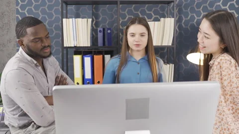 Multiethnic business team brainstorming using computer at workplace. Stock Footage 228805692