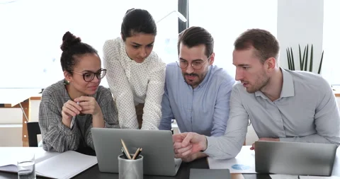 Multiethnic businesspeople working in office using computer discuss common Video stock 138810053