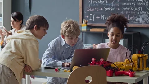 Multiethnic Children Studying Robotics and Coding on Laptop in Stem Class Stock Footage 339198145