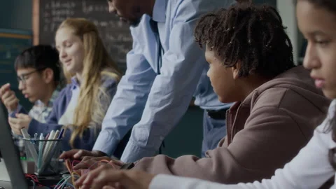 Multiethnic Class with School Teacher Working on Electronics Project Stock Footage 284437707