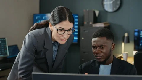 Multiethnic Colleagues Analyzing Cyber Security on Computer Stock Footage 346816267